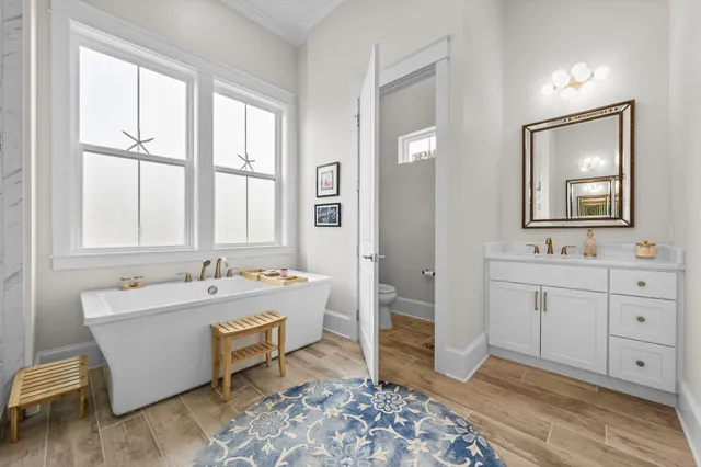 a view of a balcony with chairs and wooden floor