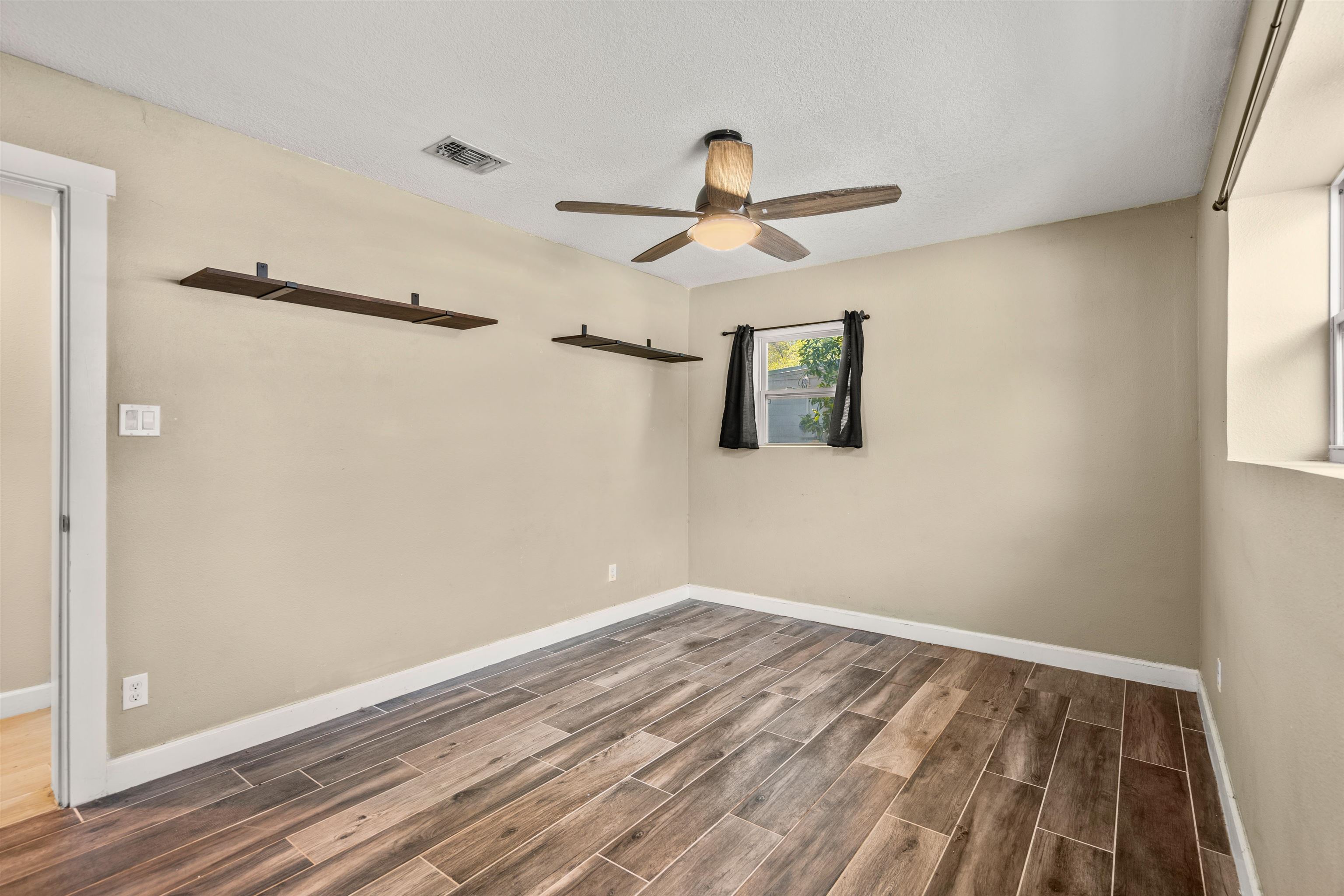 227 North Whitney Street St. Augustine, FL 32084 - Photo 15 of 35 a view of a room with wooden floor and ceiling fan