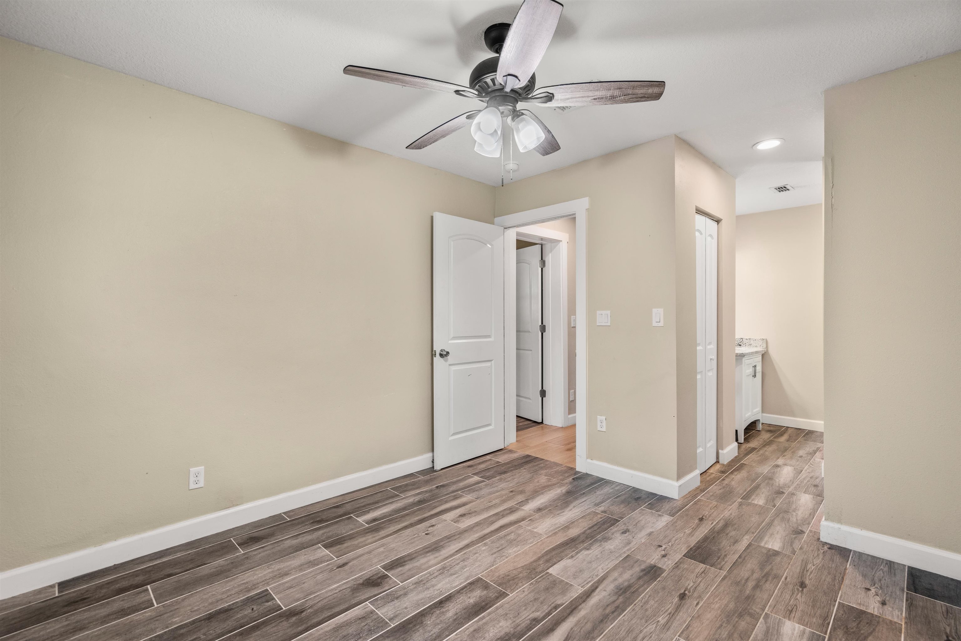 227 North Whitney Street St. Augustine, FL 32084 - Photo 20 of 35 a view of a livingroom with a chandelier fan and wooden floor