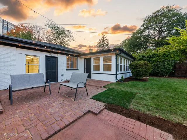 a view of a backyard with sitting area