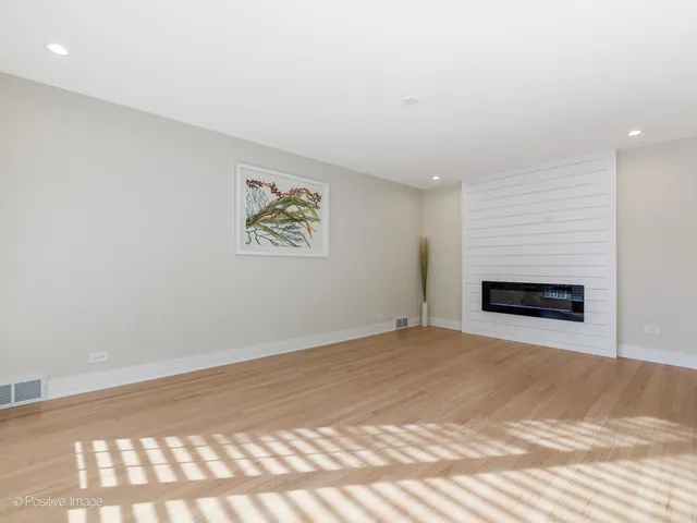a view of empty room with a fireplace