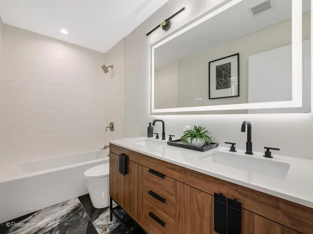 a bathroom with a double vanity sink and a bathtub