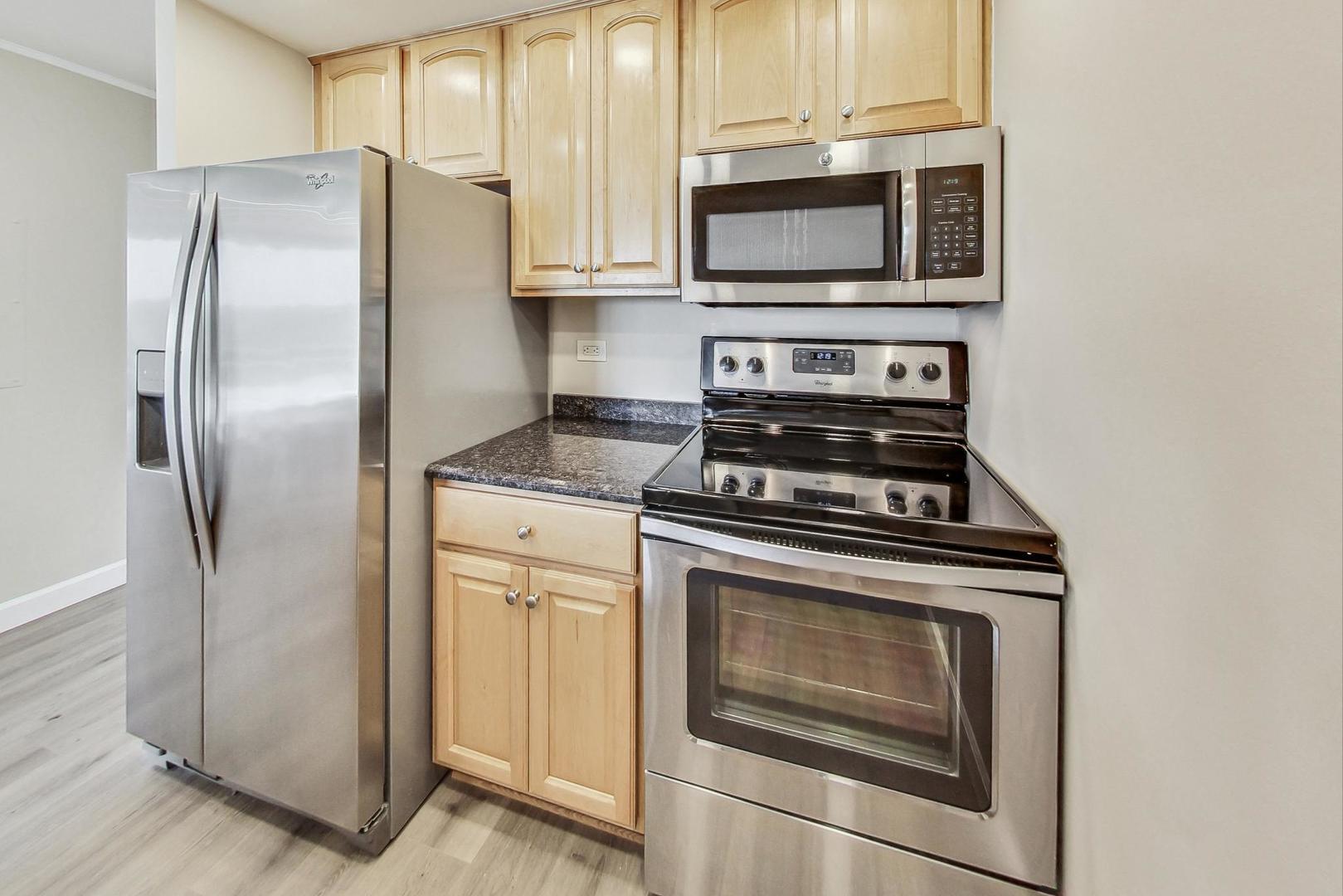 1 Renaissance Place, Unit 1220 Palatine, IL 60067 - Photo 6 of 9 a kitchen with stainless steel appliances granite countertop a stove microwave and refrigerator