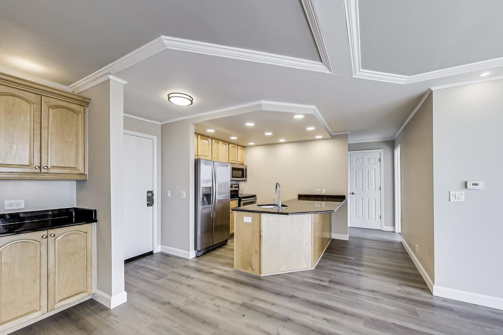 1 Renaissance Place, Unit 1220 Palatine, IL 60067 - Photo 7 of 9 a kitchen with stainless steel appliances granite countertop a stove and a refrigerator