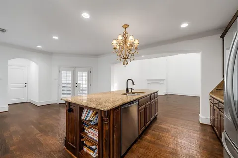 a kitchen with cabinets and chandelier
