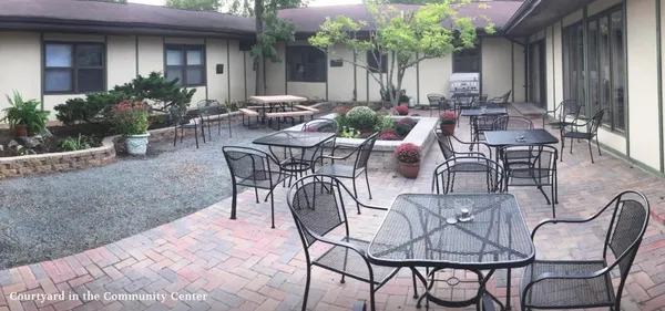 a view of a patio with couple of chairs and a table