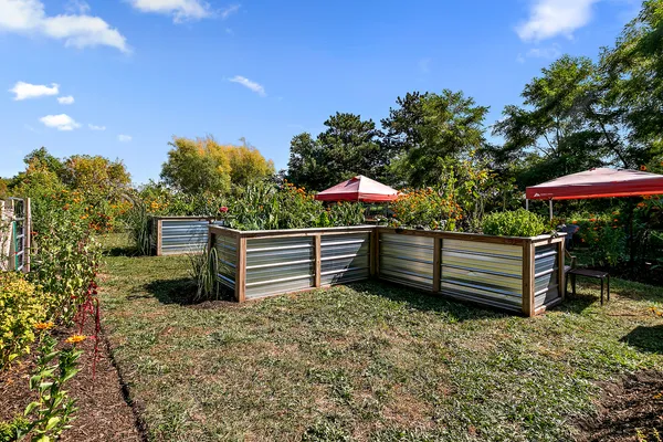 a backyard of a house with barbeque oven and outdoor seating