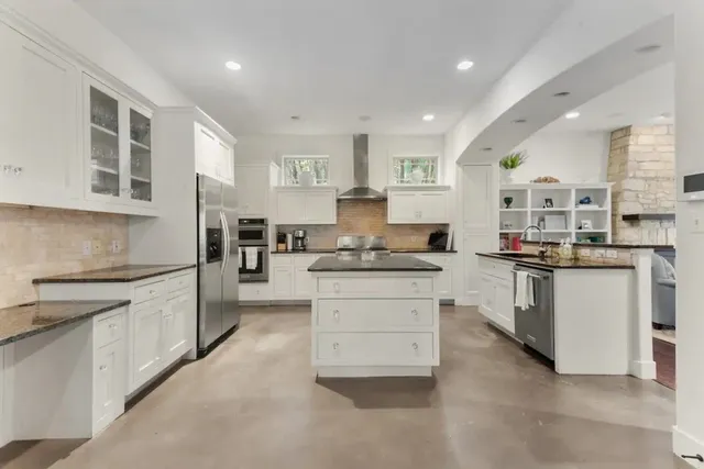 a kitchen with granite countertop white cabinets and white appliances