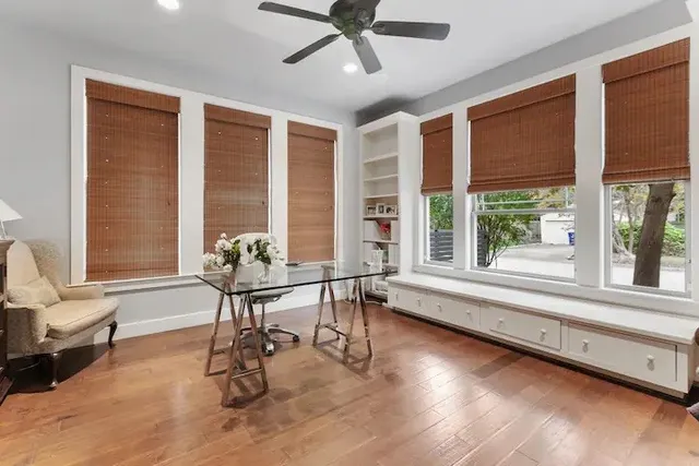 a view of a room with workspace and windows