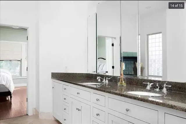 a bedroom with a bed window and a chair