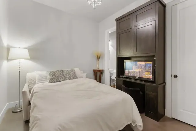 a bedroom with a bed and window