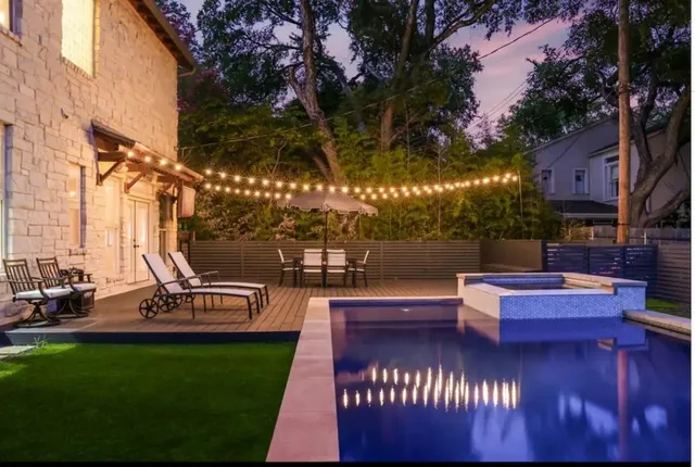 a view of a patio with dining table and chairs with a fire pit