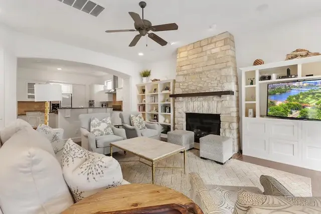 a living room with furniture and wooden floor