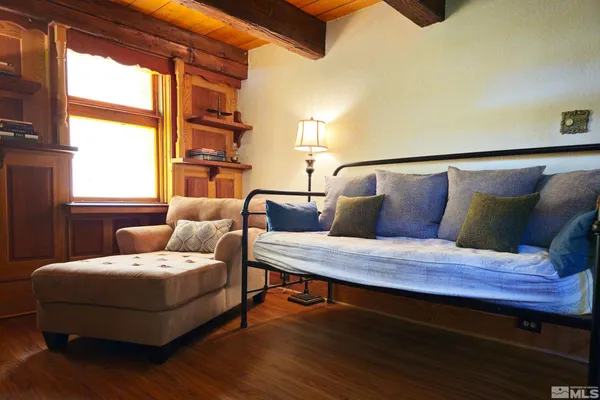 a bedroom with furniture and wooden floor