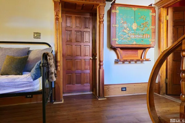 a view of front door with wooden floor and stairs