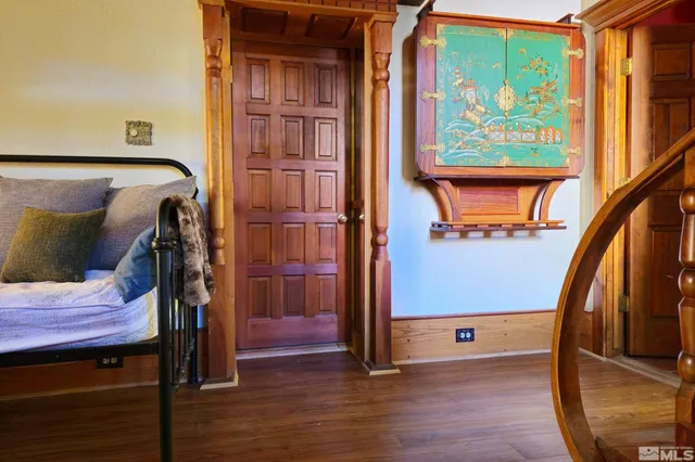 a view of front door with wooden floor and stairs