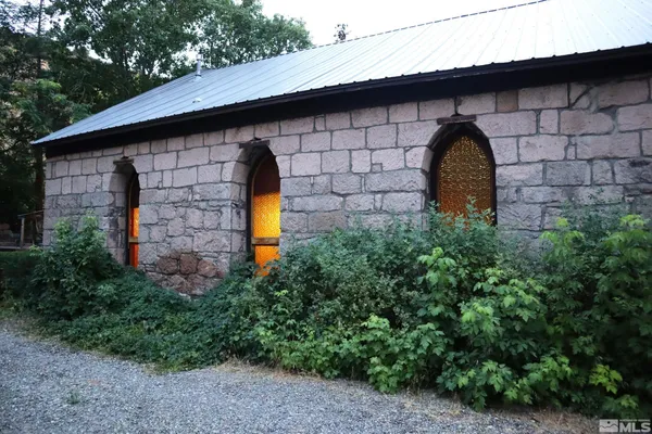 a stone house with a yard