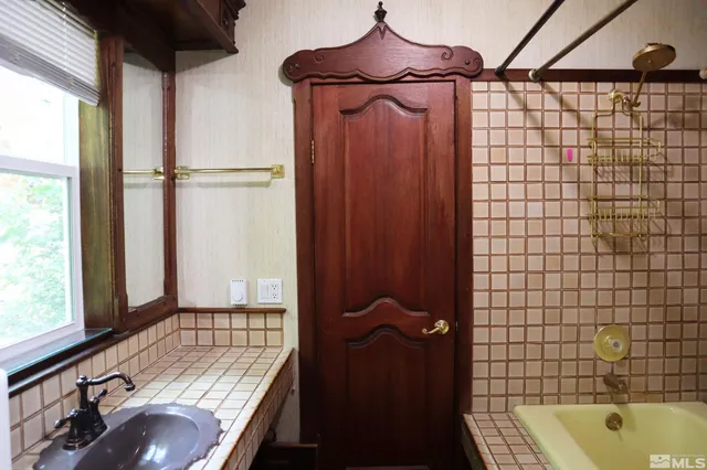 a bathroom with a bathtub and shower