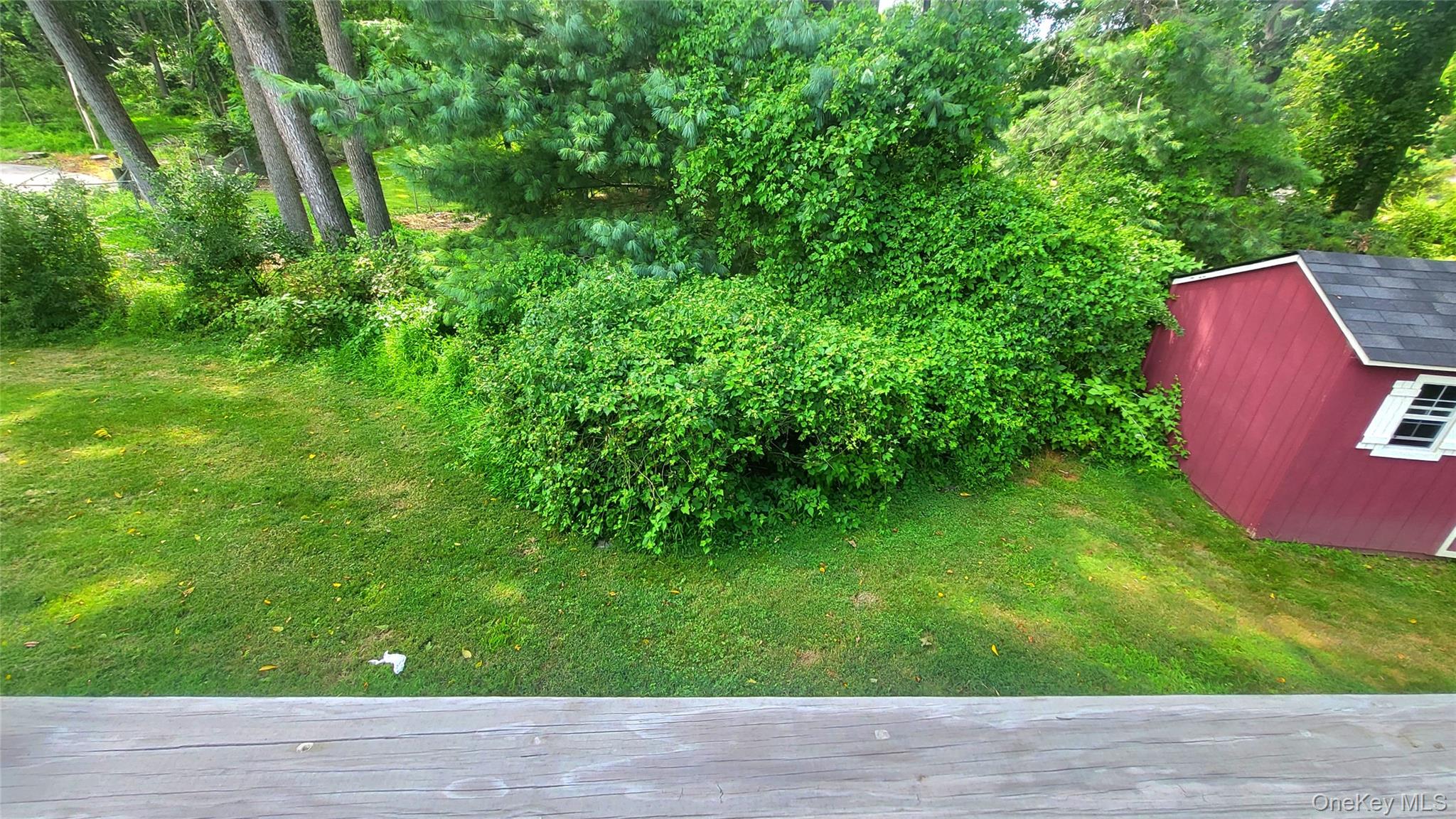 12 High Ridge Road Poughkeepsie, NY 12603 - Photo 32 of 34 Rear view of yard off deck with a storage shed