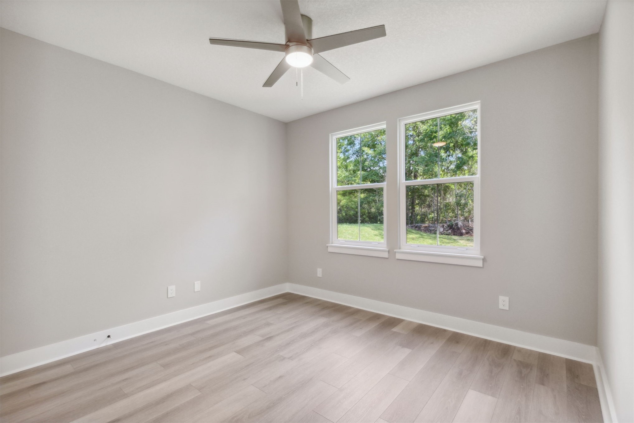 96050 Captains Pointe Road Yulee, FL 32097 - Photo 29 of 36 an empty room with wooden floor and windows
