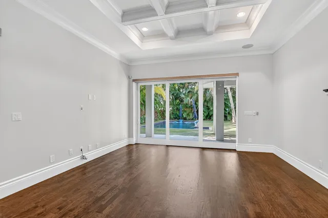 a view of wooden floor and windows in a room