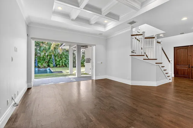 a kitchen with stainless steel appliances granite countertop a table chairs stove microwave and refrigerator