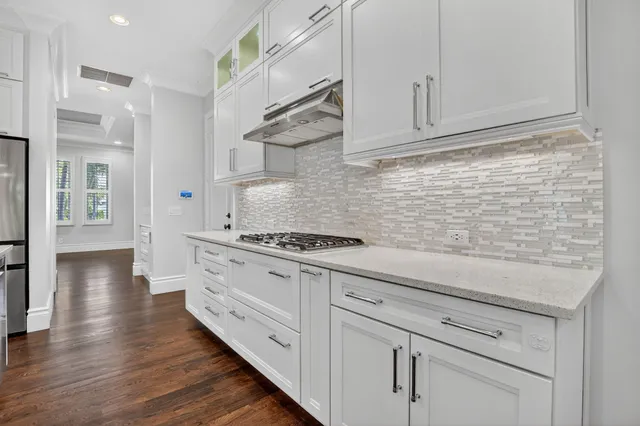 a view of a room with wooden floor and a window