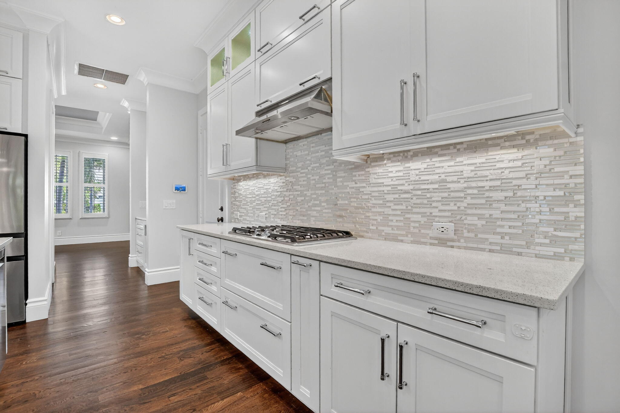 200 Northwest 10th Street Boca Raton, FL 33432 - Photo 22 of 83 a kitchen with stainless steel appliances white cabinets and a wooden floors