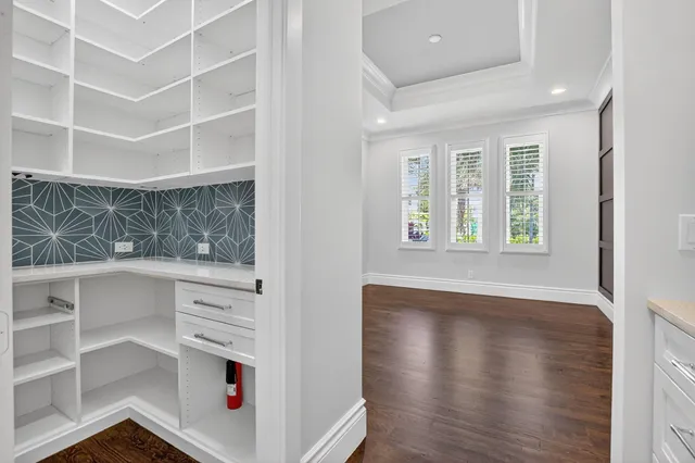 a view of a kitchen with wooden floor and a sink