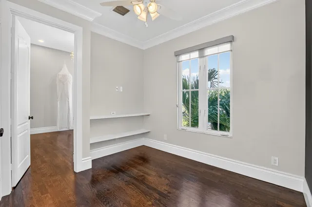 a view of walk in closet with empty racks