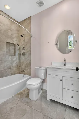 a bathroom with a sink toilet a shower and a mirror