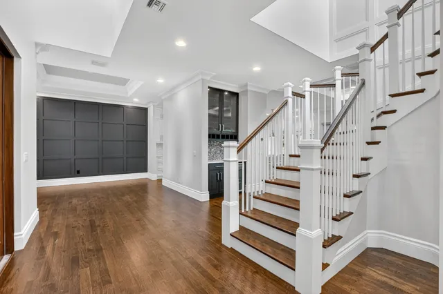 a view of entryway with wooden floor and stairs