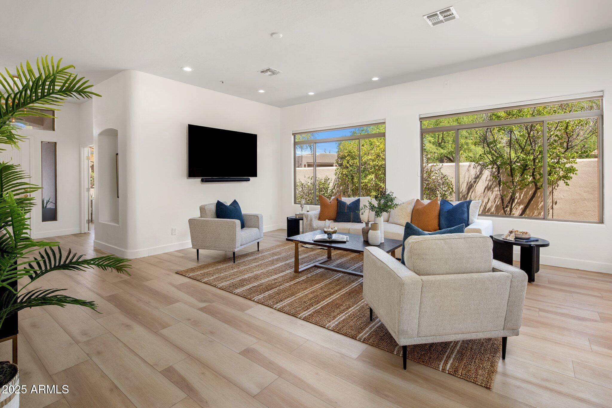8227 East Beardsley Road Scottsdale, AZ 85255 - Photo 13 of 20 a living room with furniture and a flat screen tv