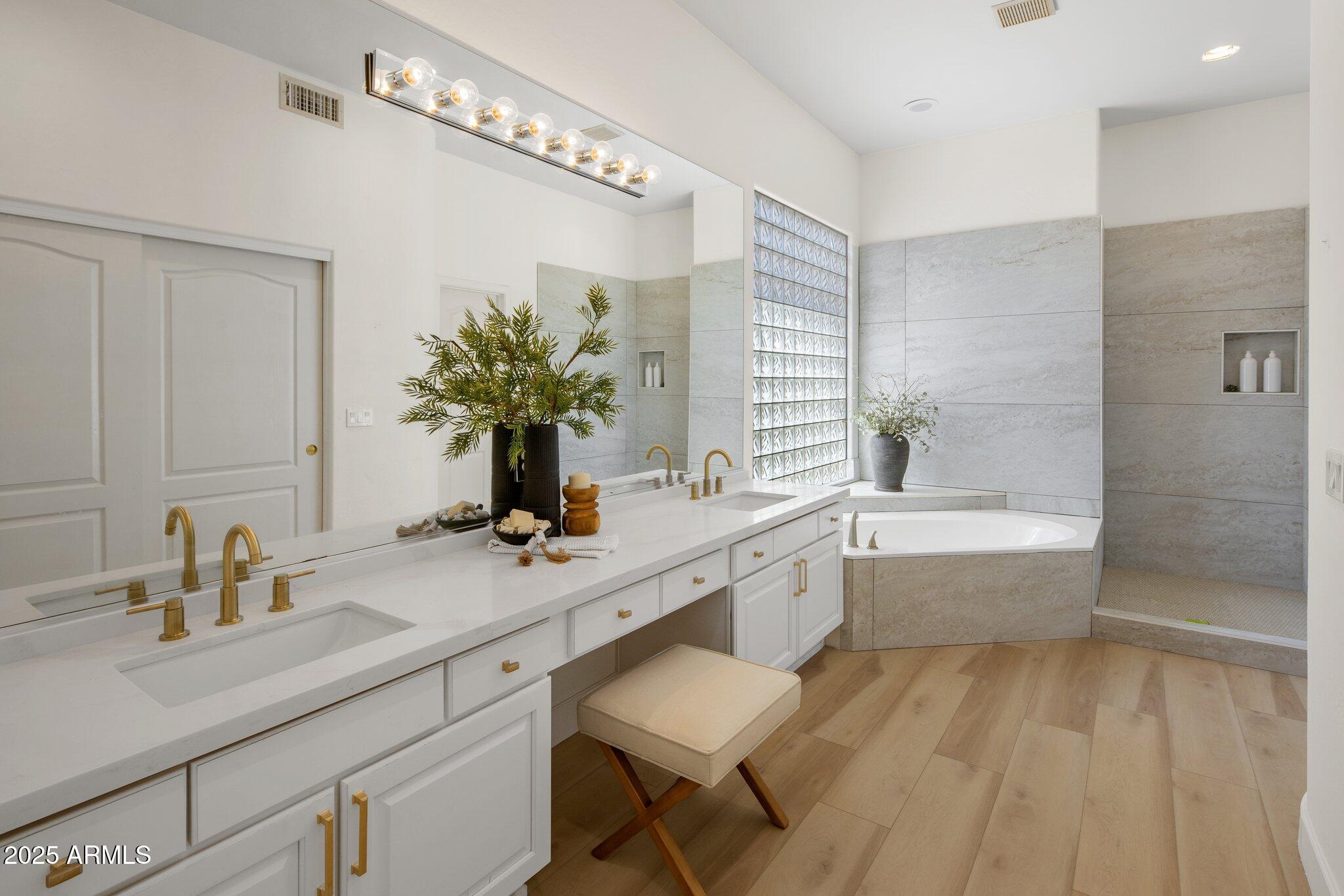 8227 East Beardsley Road Scottsdale, AZ 85255 - Photo 15 of 20 a bathroom with a sink a large mirror and a bathtub