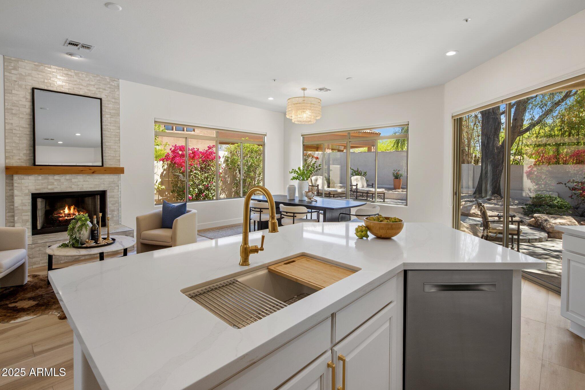 8227 East Beardsley Road Scottsdale, AZ 85255 - Photo 2 of 20 a view of kitchen island with stainless steel appliances a sink and living room view