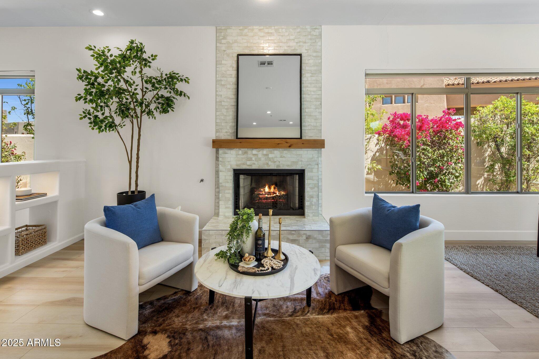8227 East Beardsley Road Scottsdale, AZ 85255 - Photo 8 of 20 a living room with furniture potted plant and a fireplace