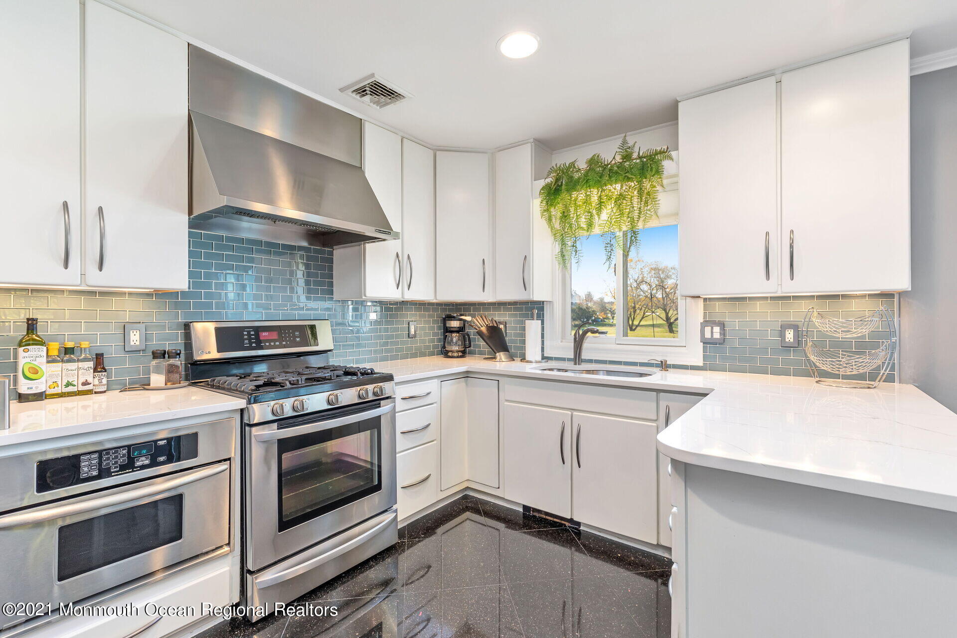 81 Portland Road Atlantic Highlands, NJ 07716 - Photo 11 of 65 a kitchen with a stove a sink and a refrigerator