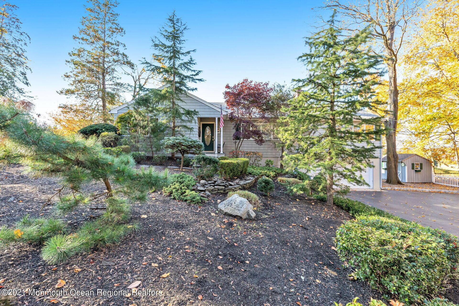 81 Portland Road Atlantic Highlands, NJ 07716 - Photo 37 of 65 a view of a backyard with plants and large trees
