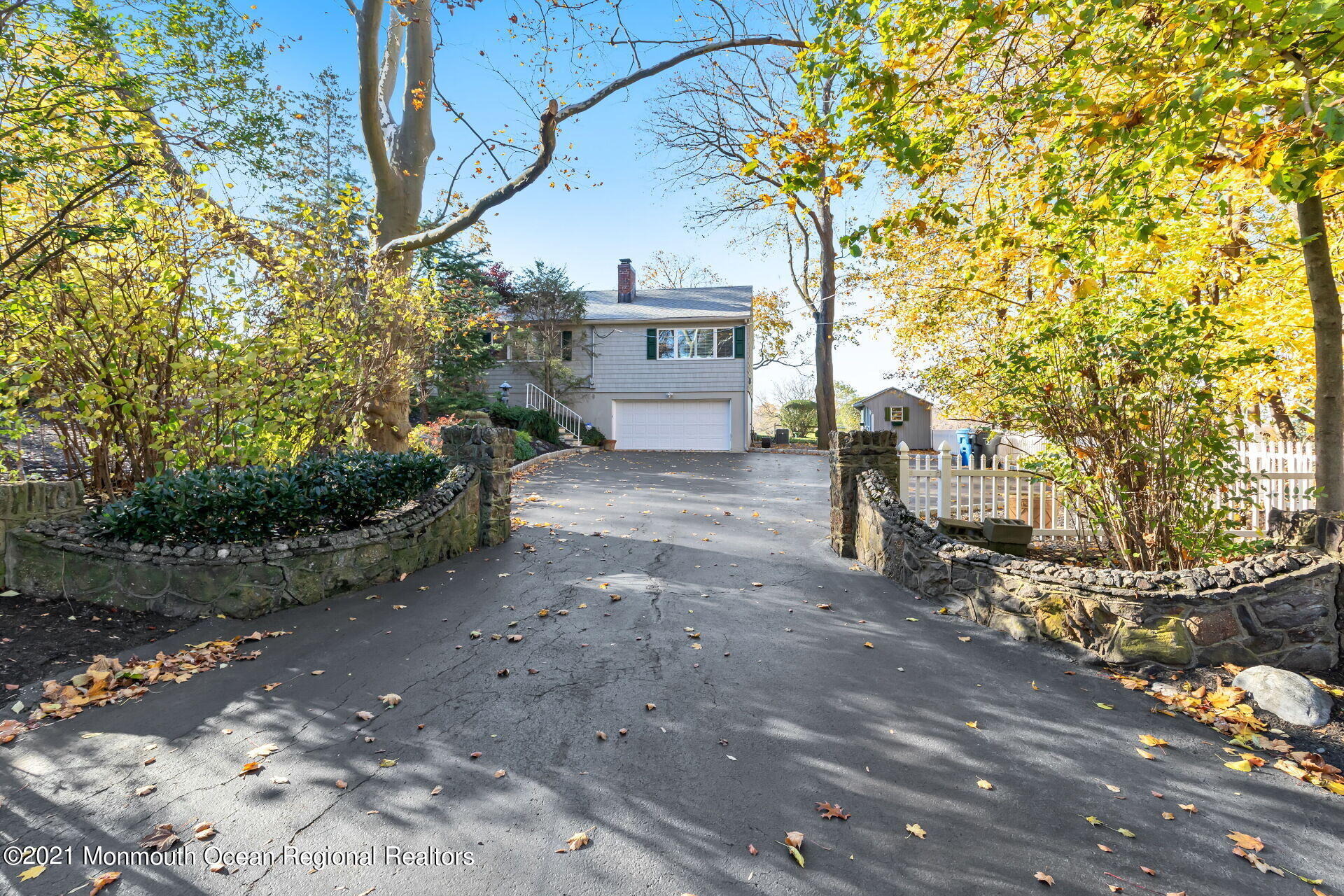 81 Portland Road Atlantic Highlands, NJ 07716 - Photo 40 of 65 a view of a brick house with a tree next to a yard