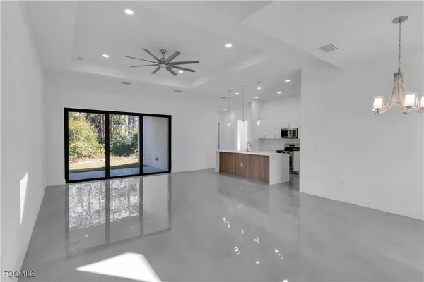 a view of a kitchen with a sink and a floor to ceiling window