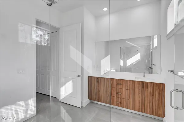 a kitchen with windows and white walls