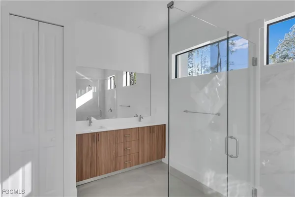 a spacious bathroom with a double vanity sink and a mirror