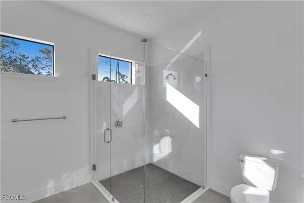 a bathroom with a shower and a mirror