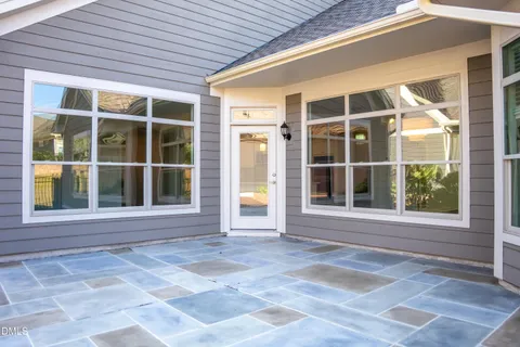 a bedroom with a bed and a flat tv screen on the dresser