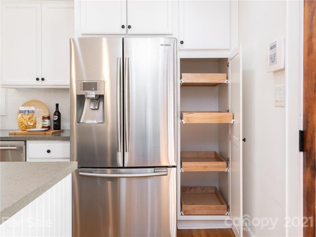 3514 Kelly Road Charlotte, NC 28216 - Photo 14 of 34 a kitchen with a refrigerator a stove and a cabinets