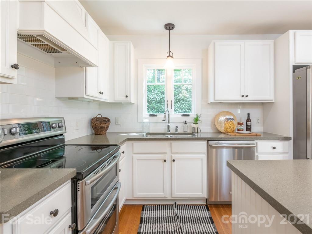 3514 Kelly Road Charlotte, NC 28216 - Photo 3 of 34 a kitchen with granite countertop a stove sink and cabinets