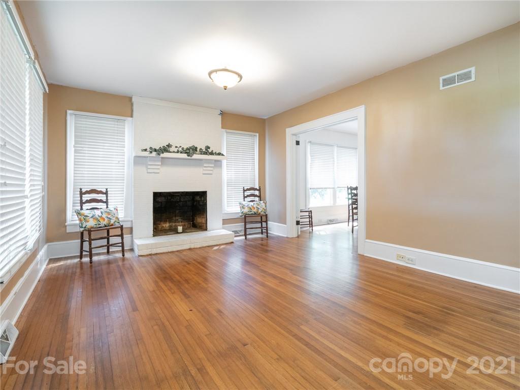 3514 Kelly Road Charlotte, NC 28216 - Photo 10 of 34 an empty room with wooden floor and fireplace