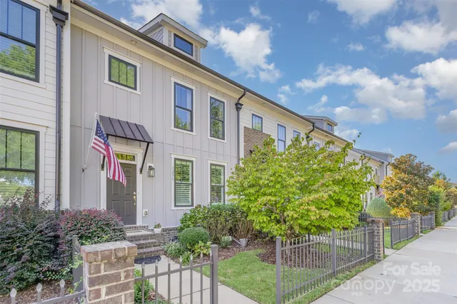 a front view of a house with plants