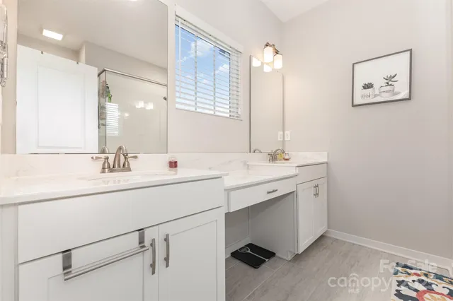 a bathroom with a sink double vanity and a mirror