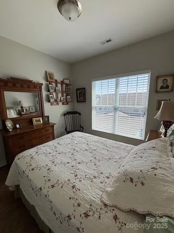 a bedroom with a bed and dresser